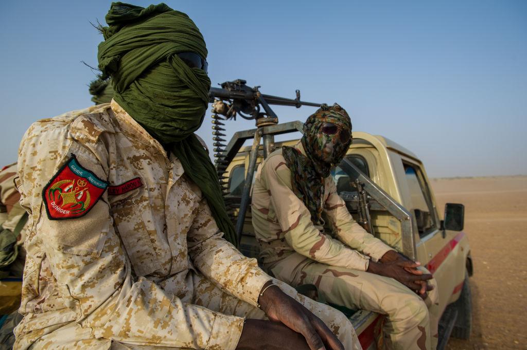 Na zdjęciu zamaskowani mężczyźni na pustyni