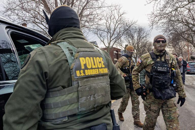 Zamaskowani funkcjonariusze amerykańskiej Straży Granicznej w trakcie patrolu na ulicy