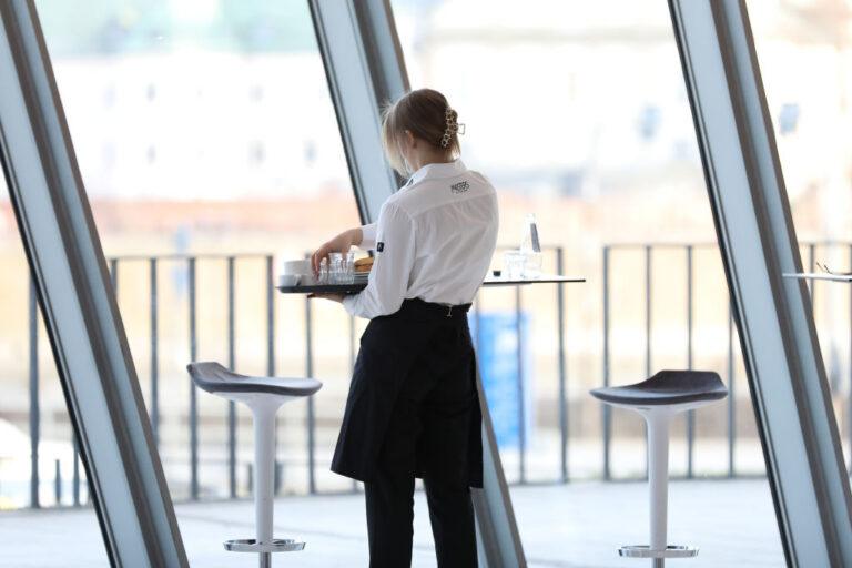 A waitress cleans a table