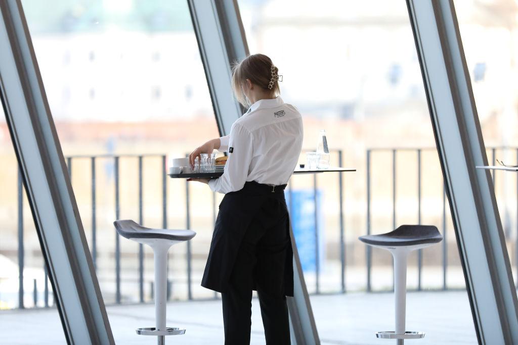 A waitress cleans a table