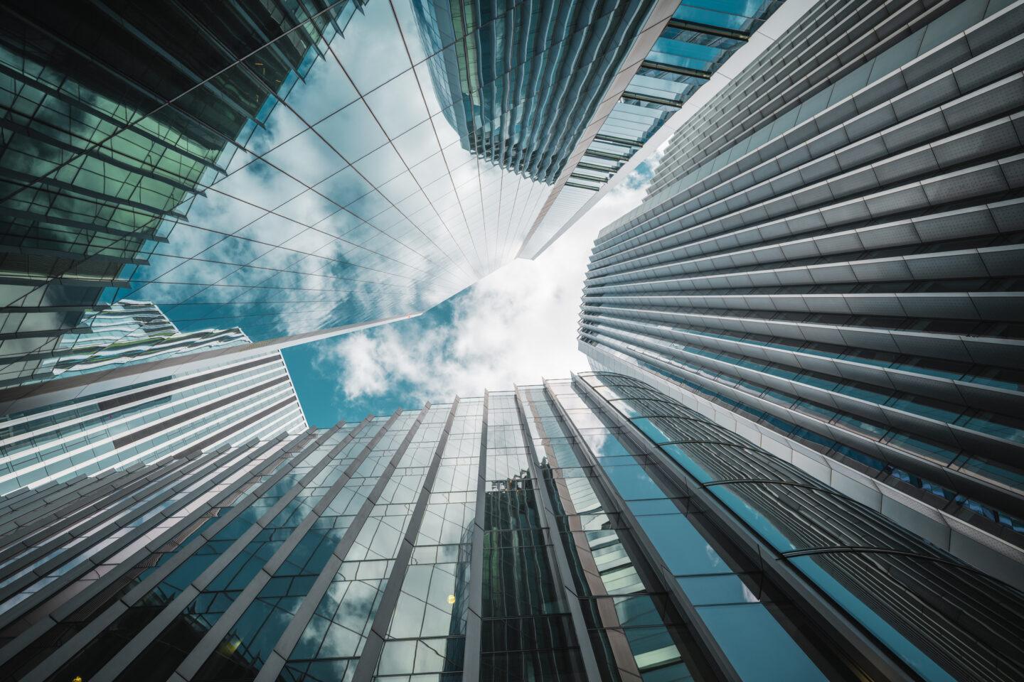 Skyscrapers thrust upward in a glassy urban canyon, capturing modern architecture, ambition, and aerial perspective, London, UK