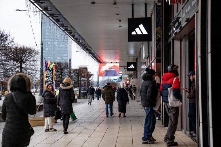 Przechodnie w trakcie spaceru po alejce handlowej na ulicach Warszawy