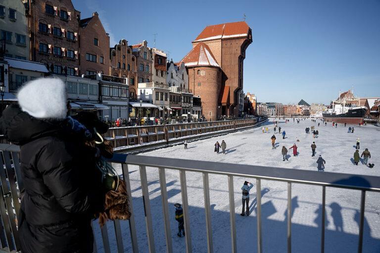 General view of people walking on the frozen Motlawa River on February 1, 2026 in Gdansk, Poland.