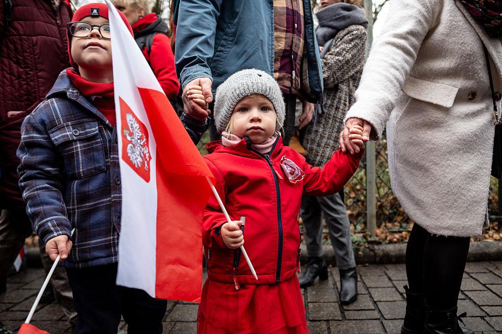 Families with Polish National flags participate in the