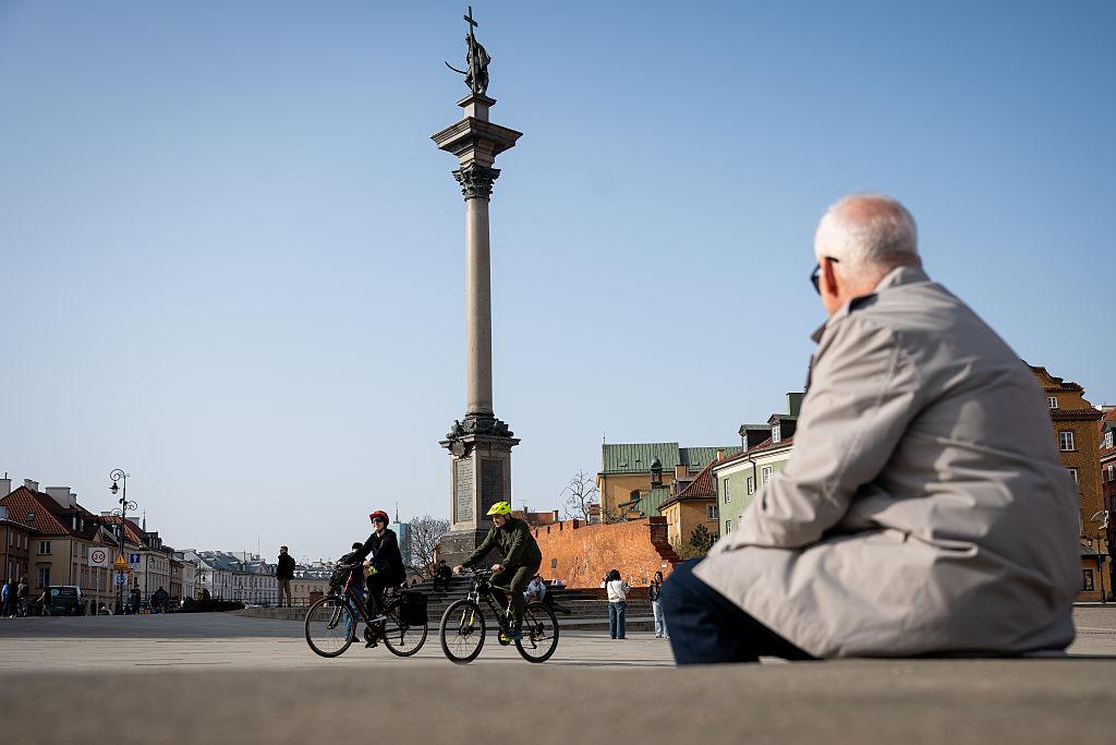 Cyclists ride across Castle Square enjoying the warm weather