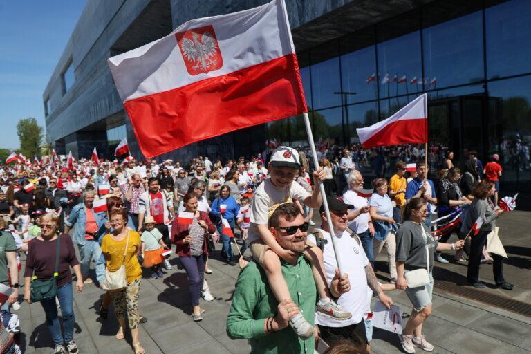 Tłum przechodniów z flagami Polski